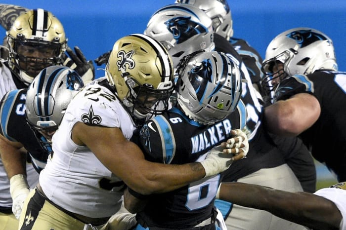 Jan 3, 2021; Carolina Panthers quarterback P.J. Walker (6) throws an interception as he is hit by New Orleans Saints defensive end Marcus Davenport (92). Mandatory Credit: Bob Donnan-USA TODAY